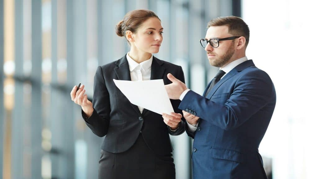 Two colleagues talking at work