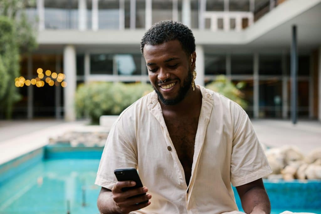 man using phone smiling