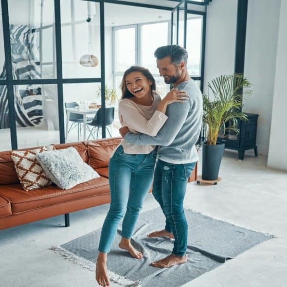 A couple hugging in the living room