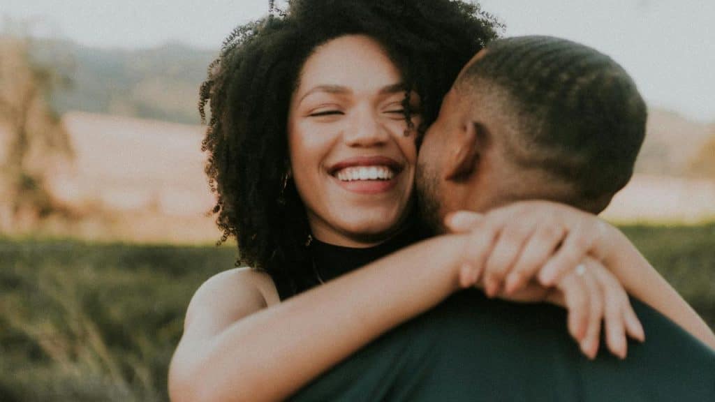 A happy woman hugging a man