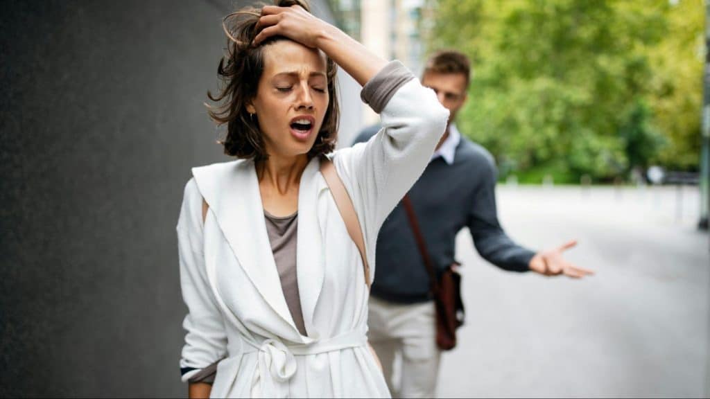 A man explaining to an upset woman 