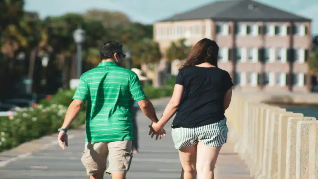 couple holding hands during walk