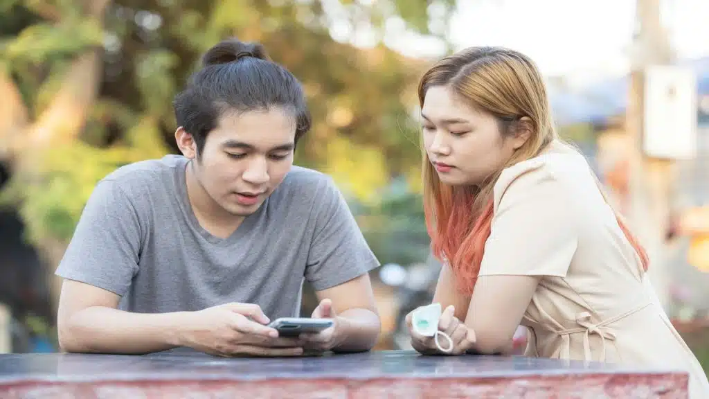 man distracted while partner looks ignored