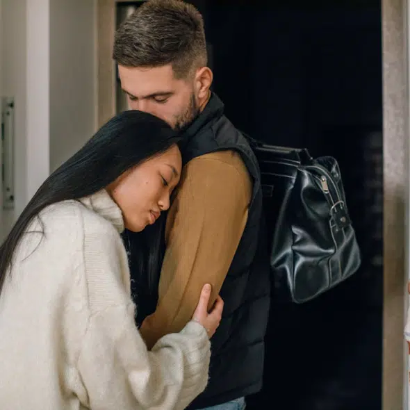 A man kissing a woman’s head