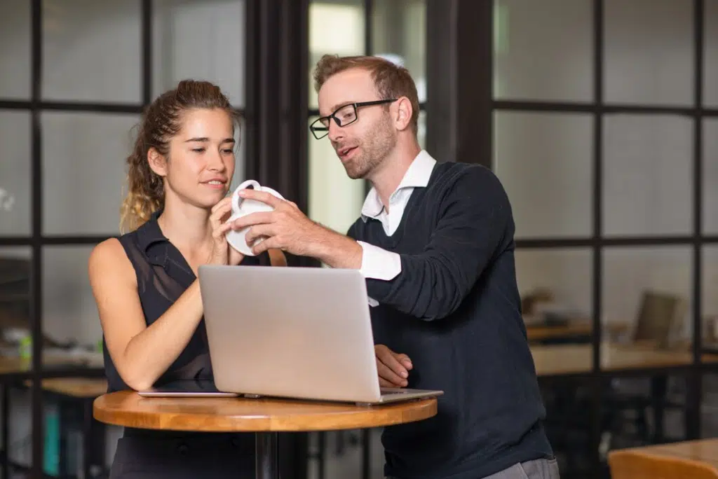 Business partners chatting and working at cafe table