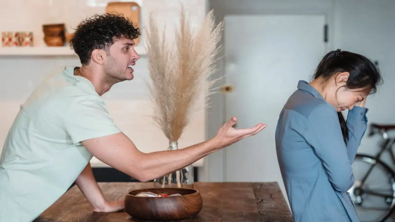 A couple fighting in the kitchen