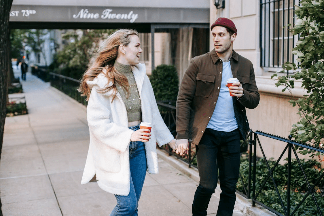 Happy young couple walking on the street