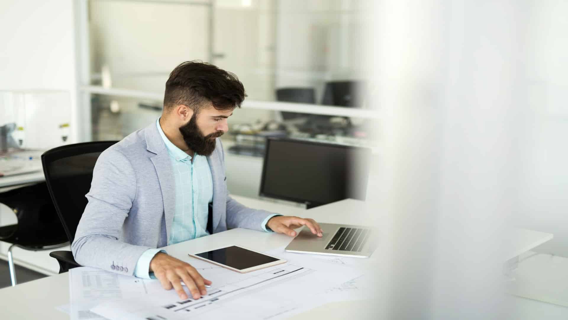man working on laptop at desk