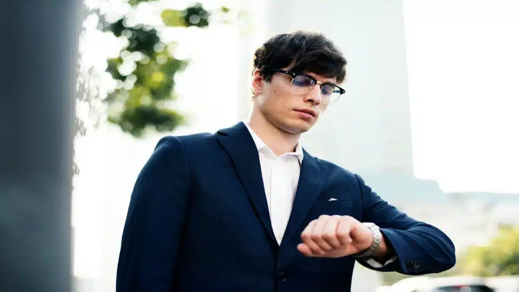 A man looking at his wrist watch