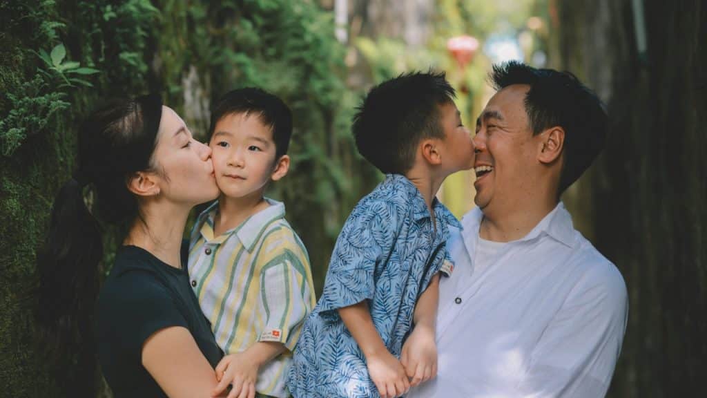 A family sharing a tender moment outdoors.