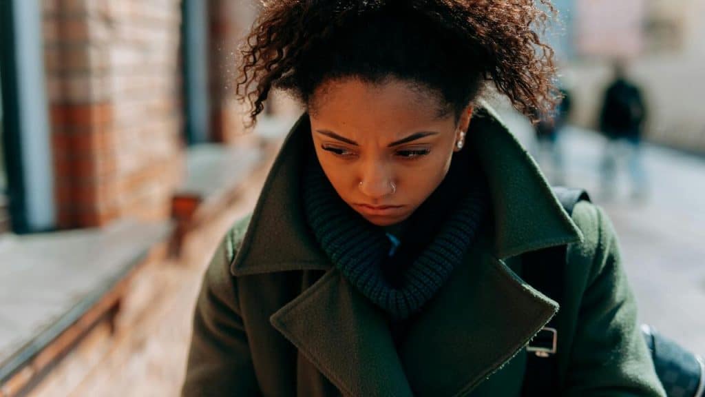 A woman looking sad while walking home