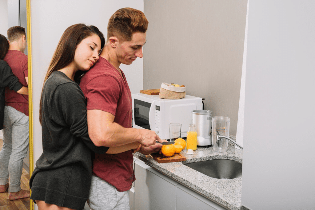 A man making a drink for woman