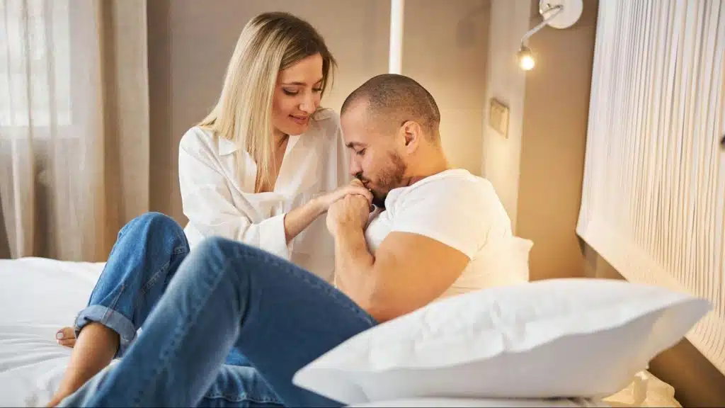 A man kissing woman’s hand