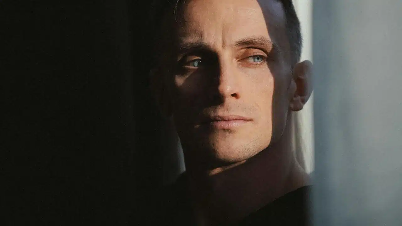 A close-up of a man gazing sideways
