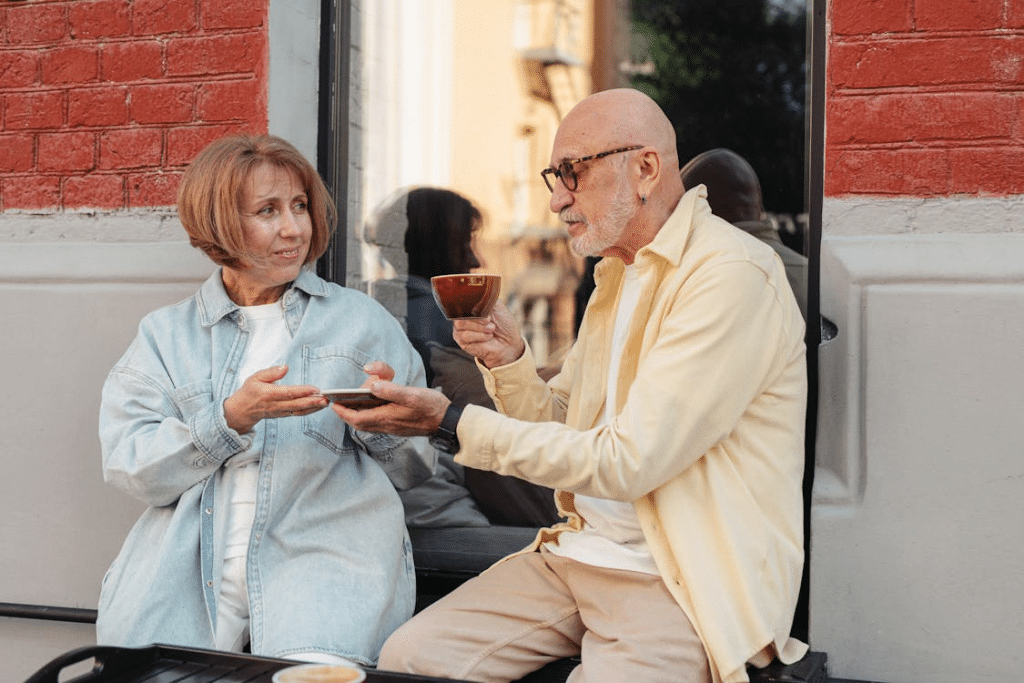 Couple sitting outdoors having coffee