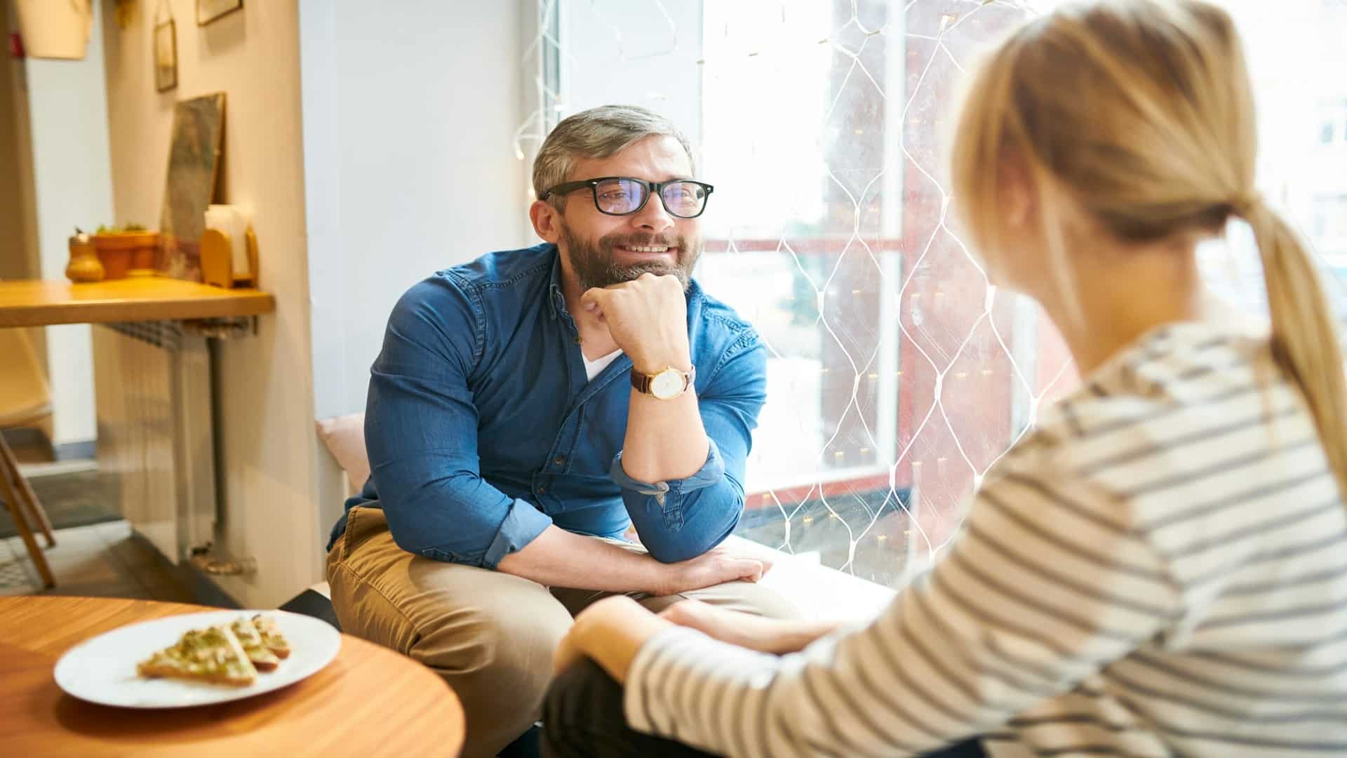 man listening closely during conversation