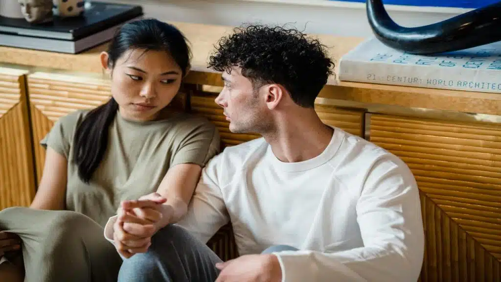 A couple sitting on the floor