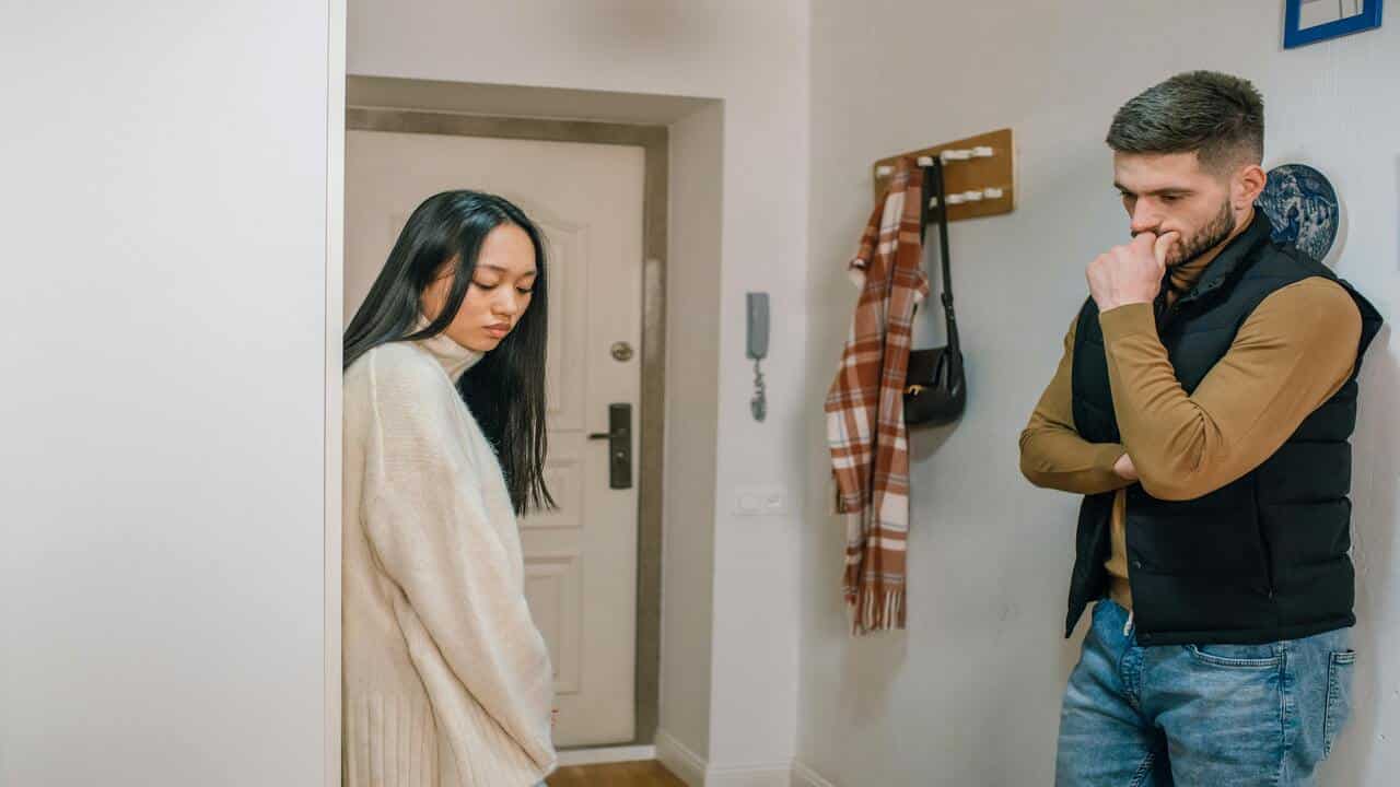 A couple looking upset by the entryway