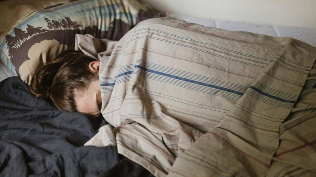 A person lying in bed covered by blankets, appearing to rest or sleep.Not every disagreement requires a full resolution before bed. Sometimes the best thing you can do is agree to disagree, or decide that whatever you're arguing about really doesn't matter enough to keep going. The "never go to bed angry" advice sounds nice but it's created way more problems than it's solved. Some fights need time and distance to cool down.