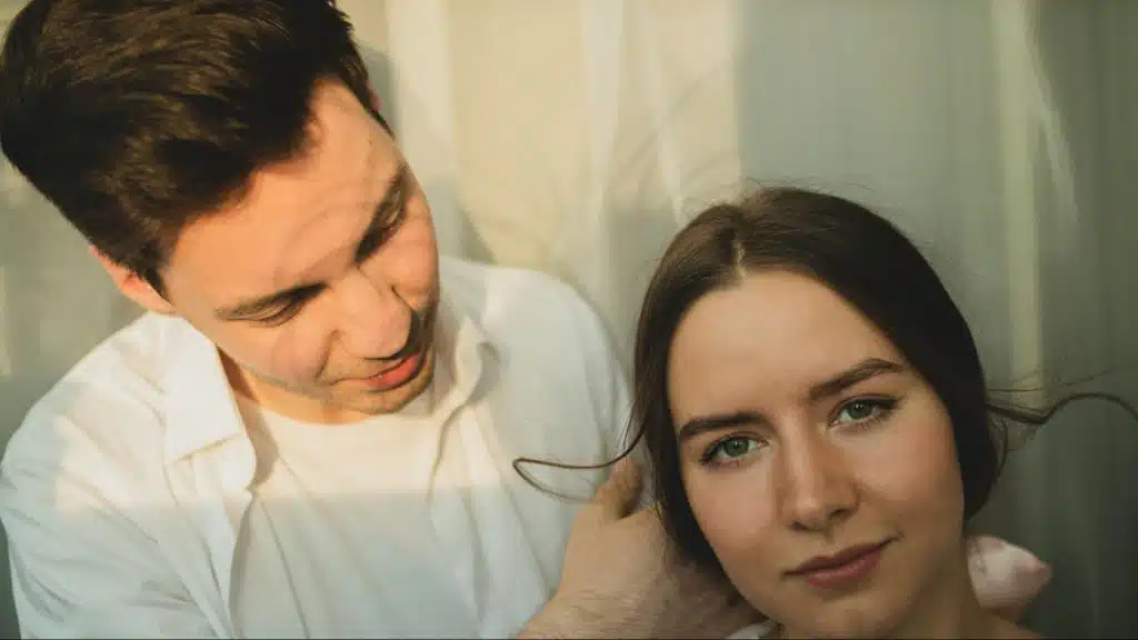 A man holding woman’s head