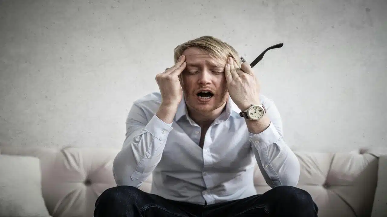 Tired man touching his head