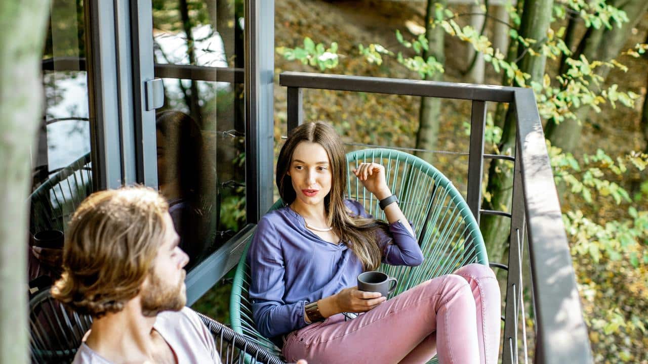 A couple sitting on a balcony