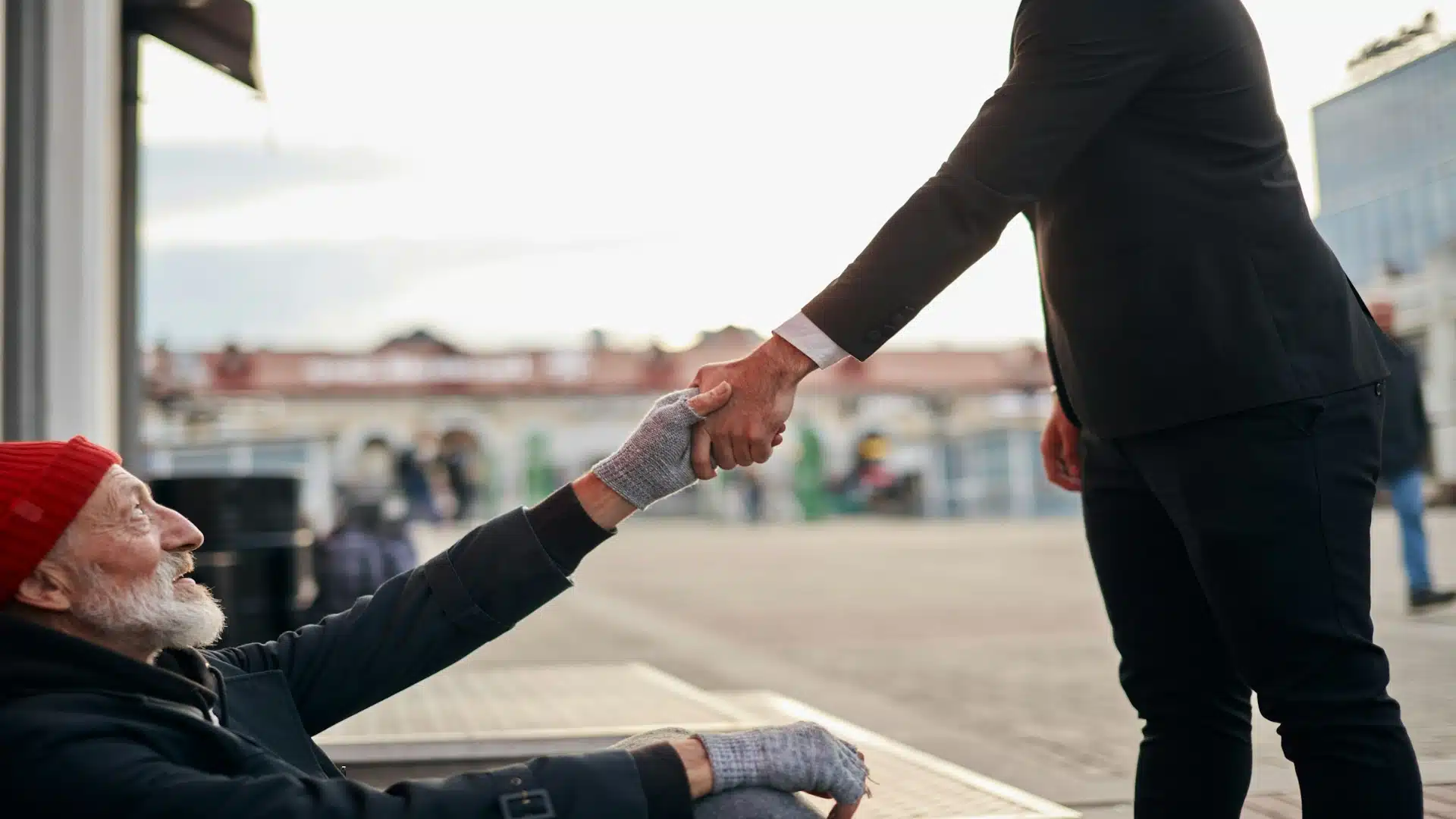 man helping someone outdoors