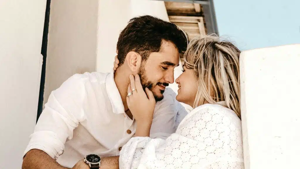 Smiling man and woman about to kiss.