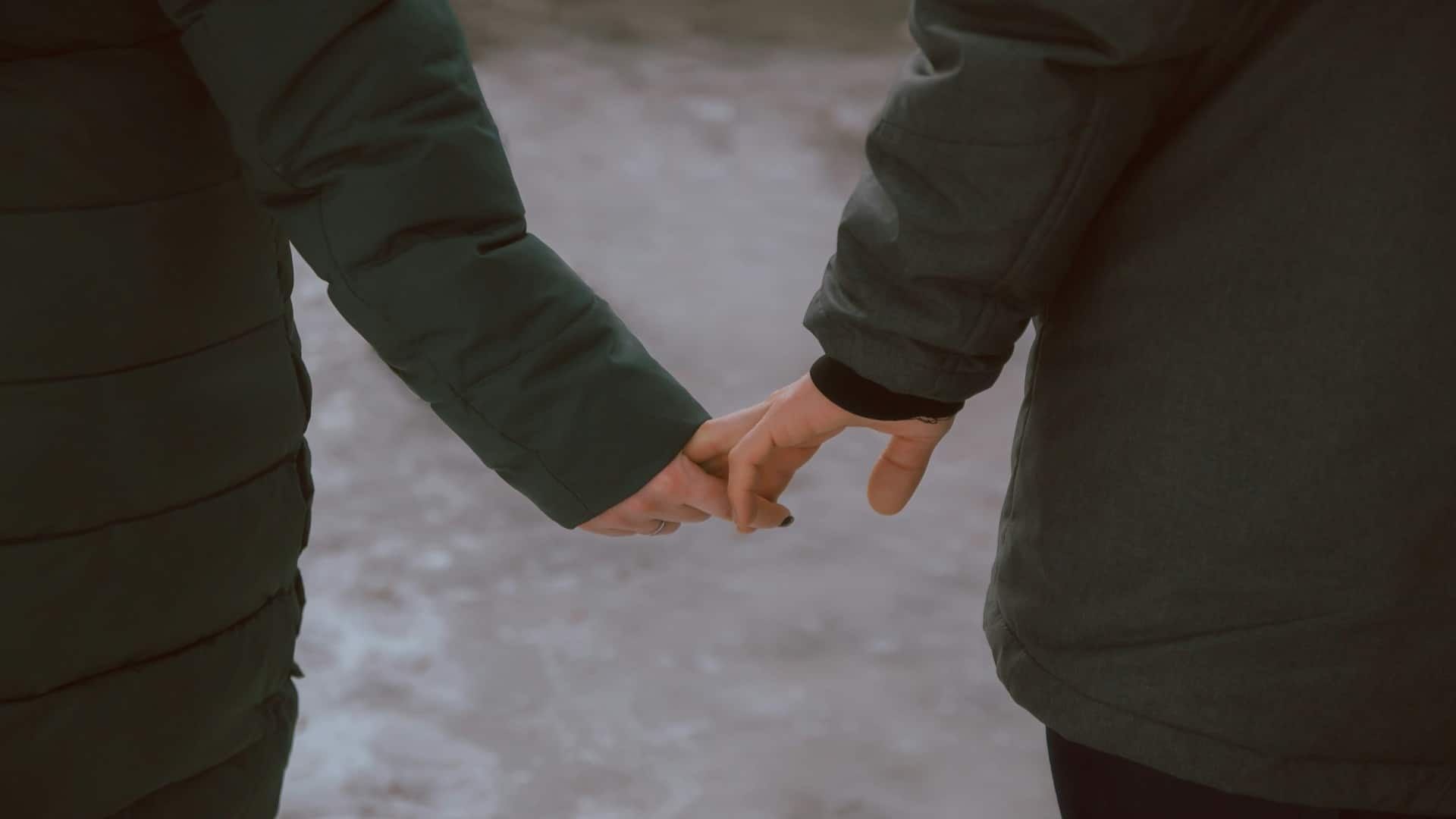 couple holding hands during conversation