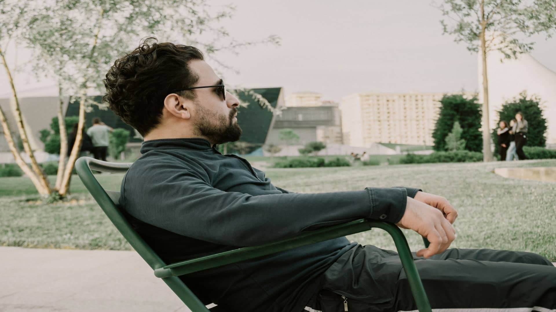 man sitting thoughtfully outdoors