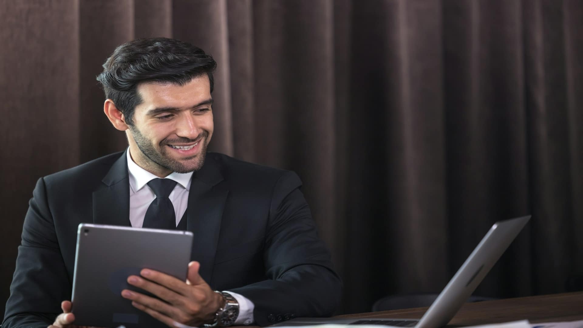 man smiling after work success