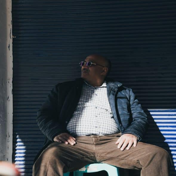 man sitting thoughtfully during conversation