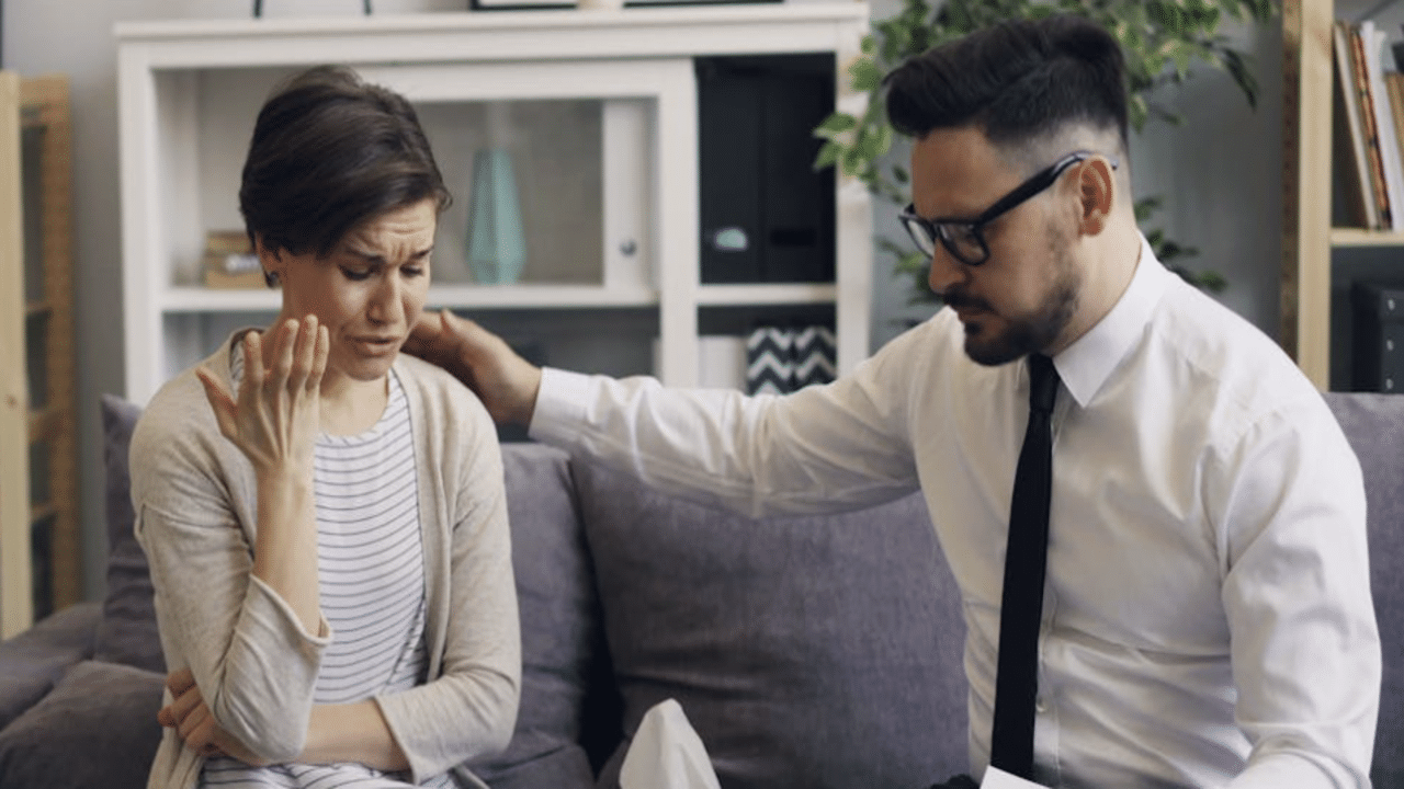 A man comforting his wife