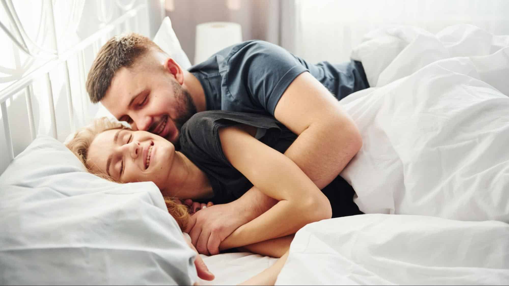 A man cuddling woman