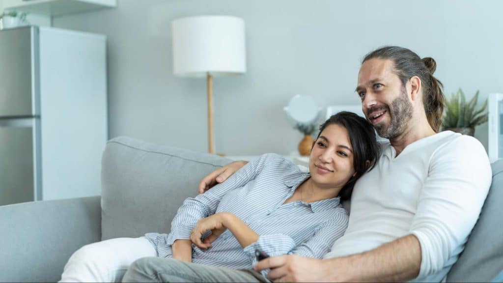 A man and woman talking about what they are watching