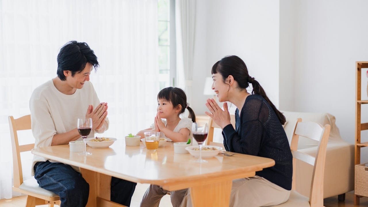 Family eating lunch in the dining room.