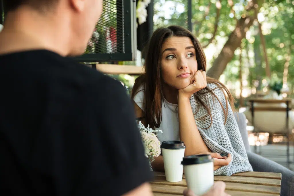 A woman thinking and a man in front of her