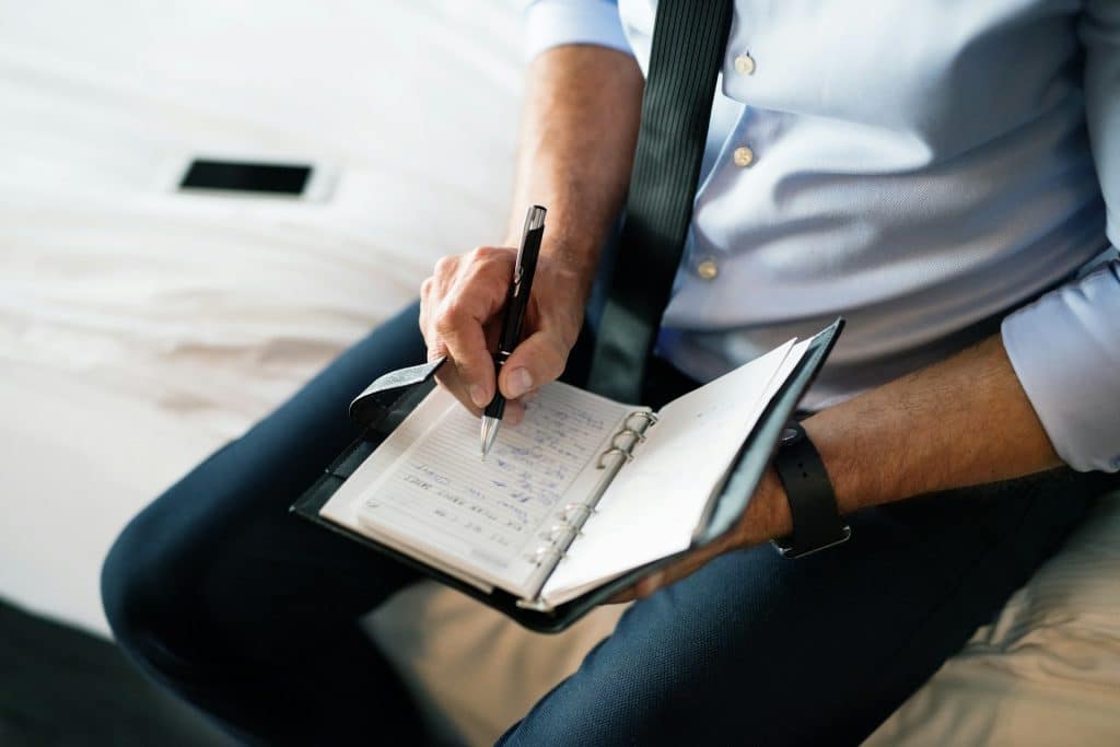man planning notebook desk