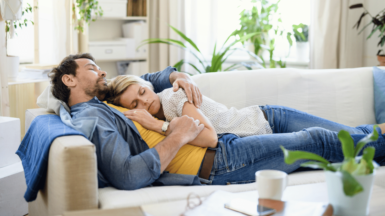 A couple sleeping on the couch