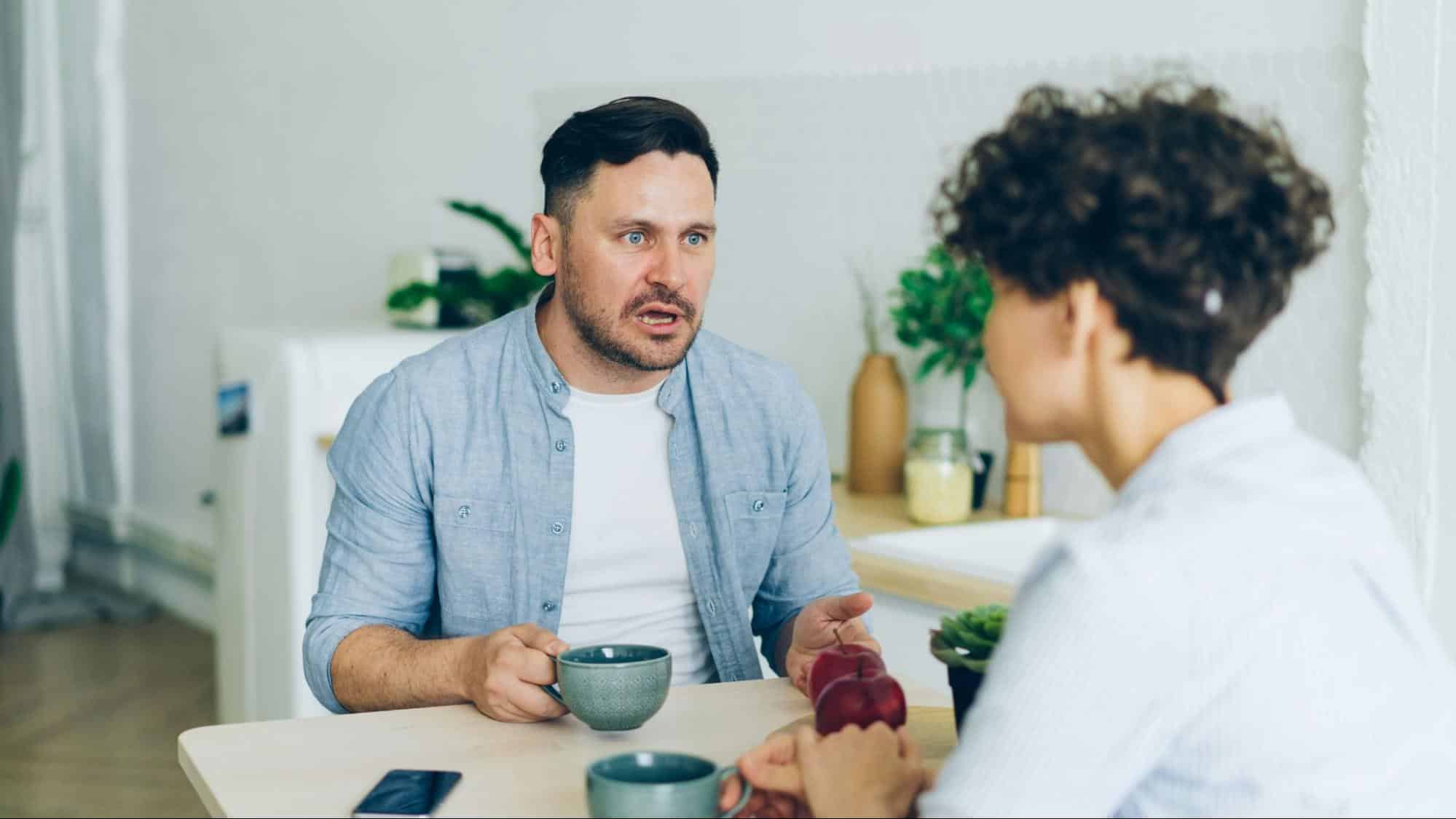 A man being confronted by a woman