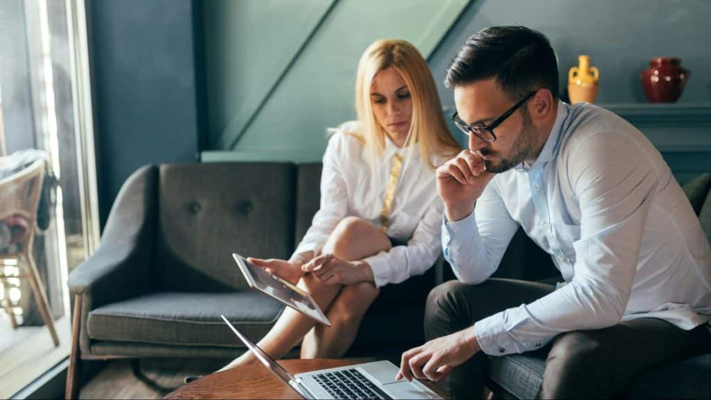 A man busy working and ignoring a woman