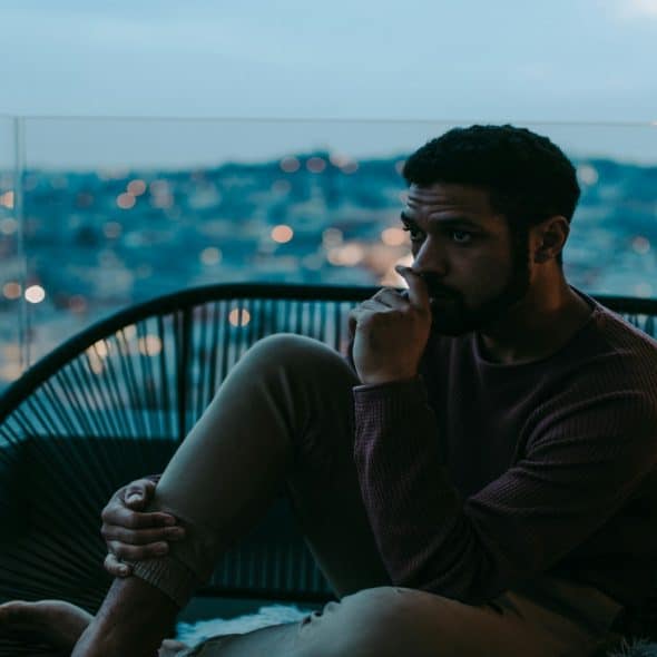 man sitting thoughtfully during conversation
