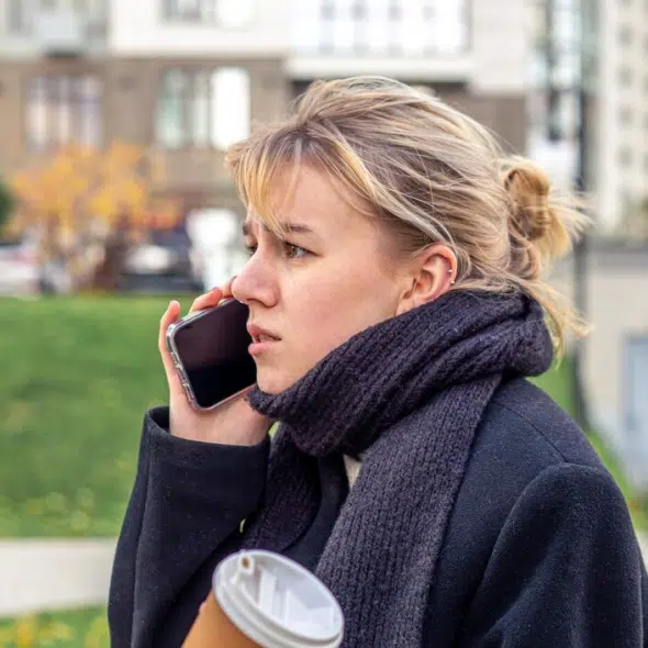 Angry and stressed young woman talking on the phone