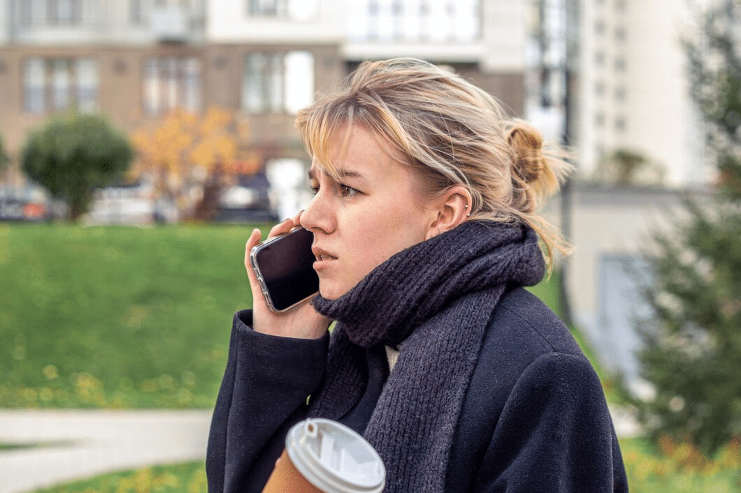 Angry and stressed young woman talking on the phone