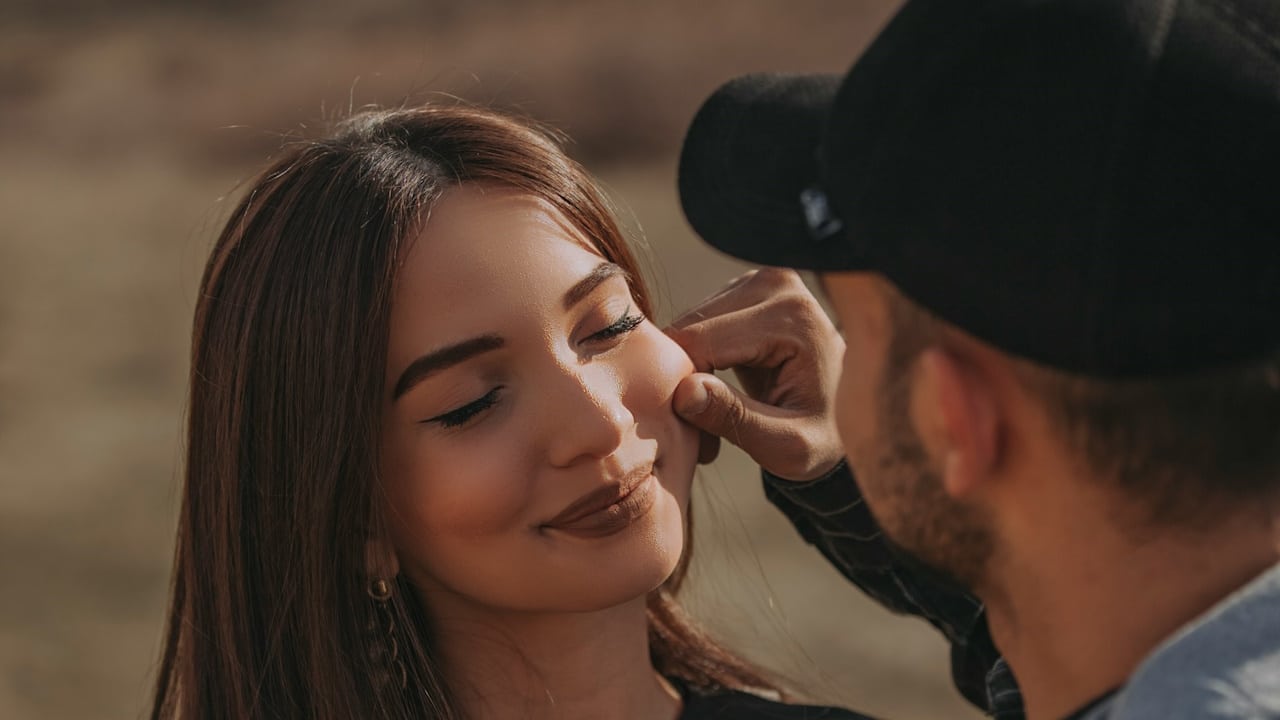 A man and woman smiling during daytime.