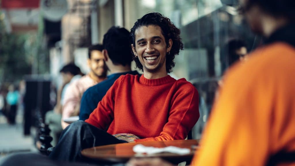 man smiling during conversation