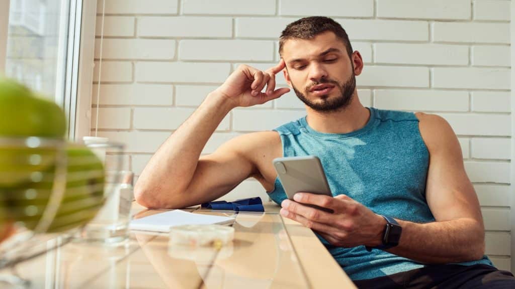 man looking at phone thoughtfully