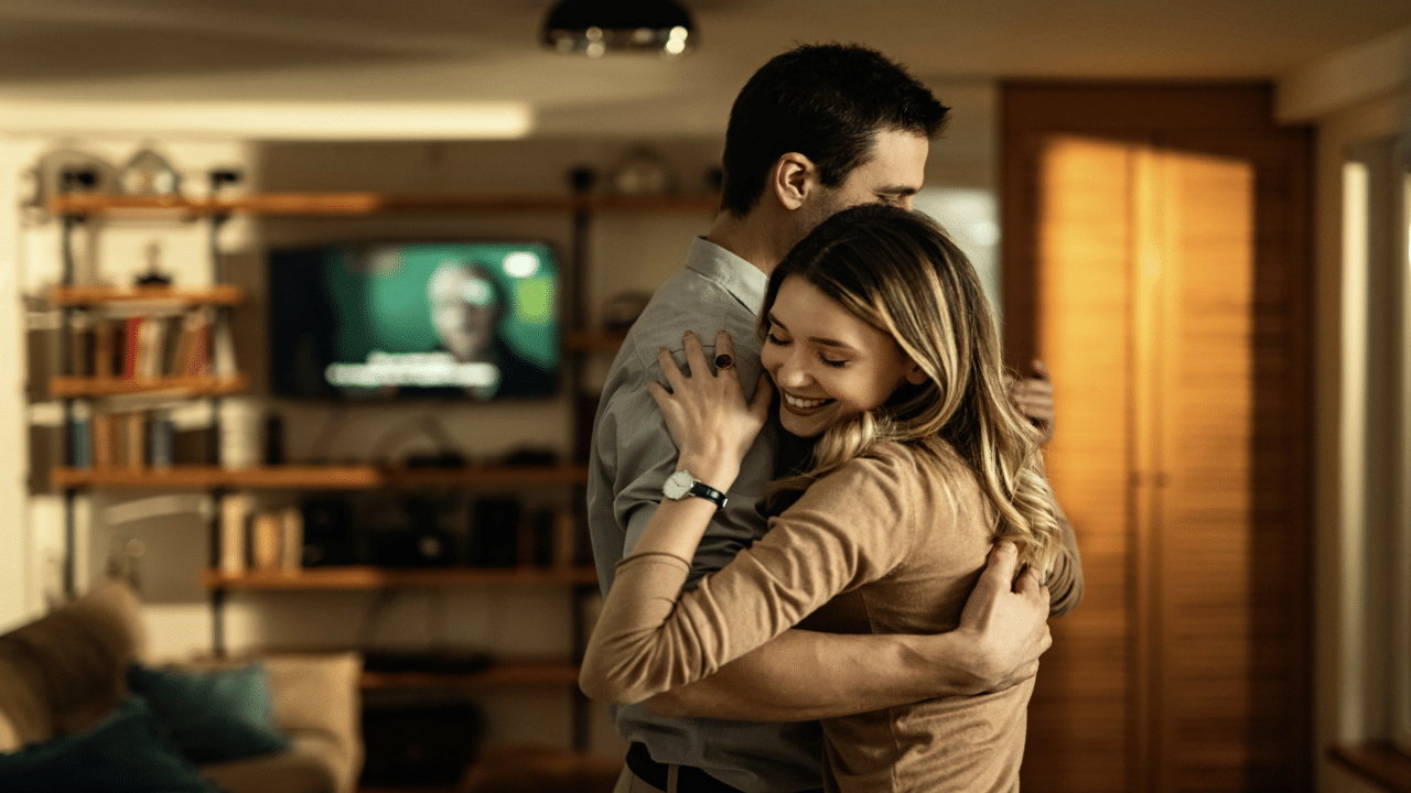 A couple dancing in the living room
