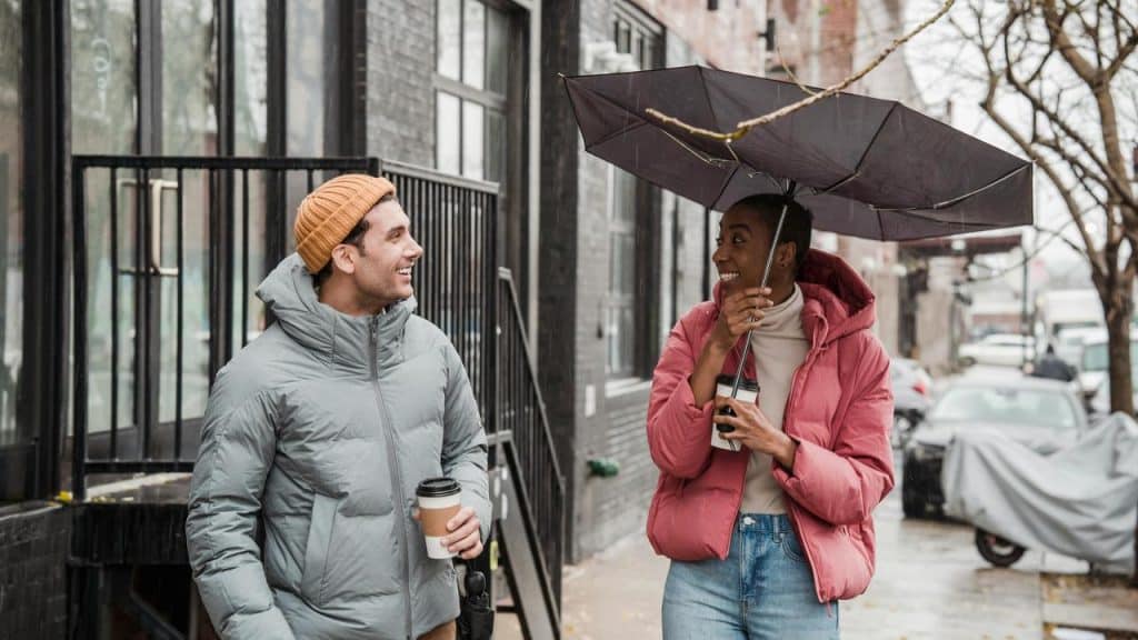 A man and woman walking on a rainy street