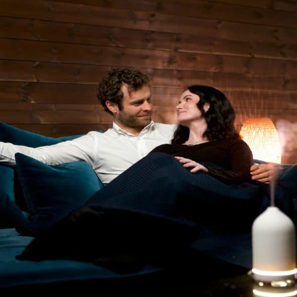 couple sitting quietly on couch